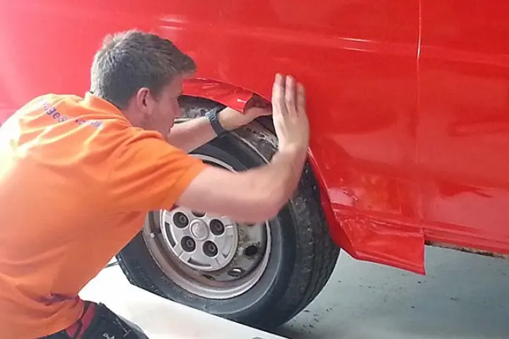 man applying vinyl to a vehicle