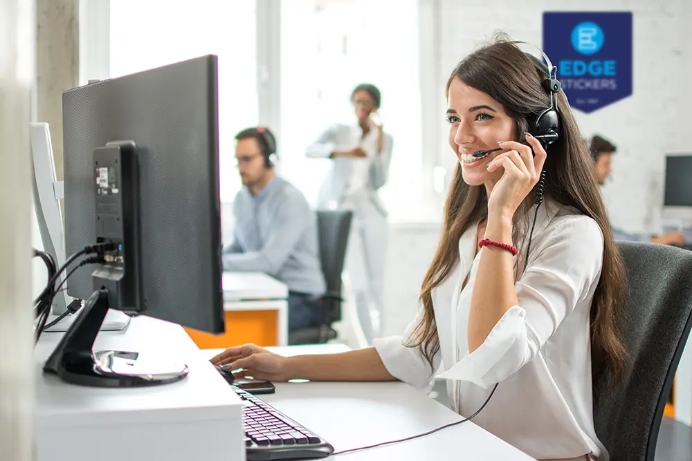female customer service operator on the phone in front of a computer