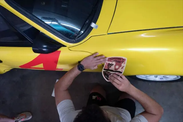 man applying a vinyl car sticker